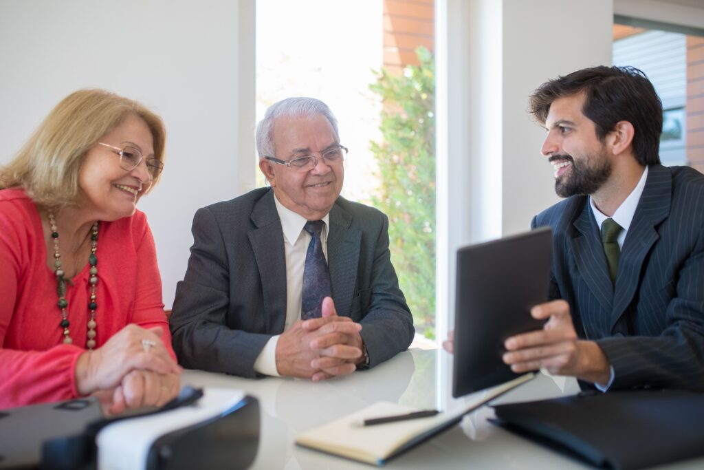 Senior couple in Brisbane consulting a retirement financial advisor about planning costs and fees.